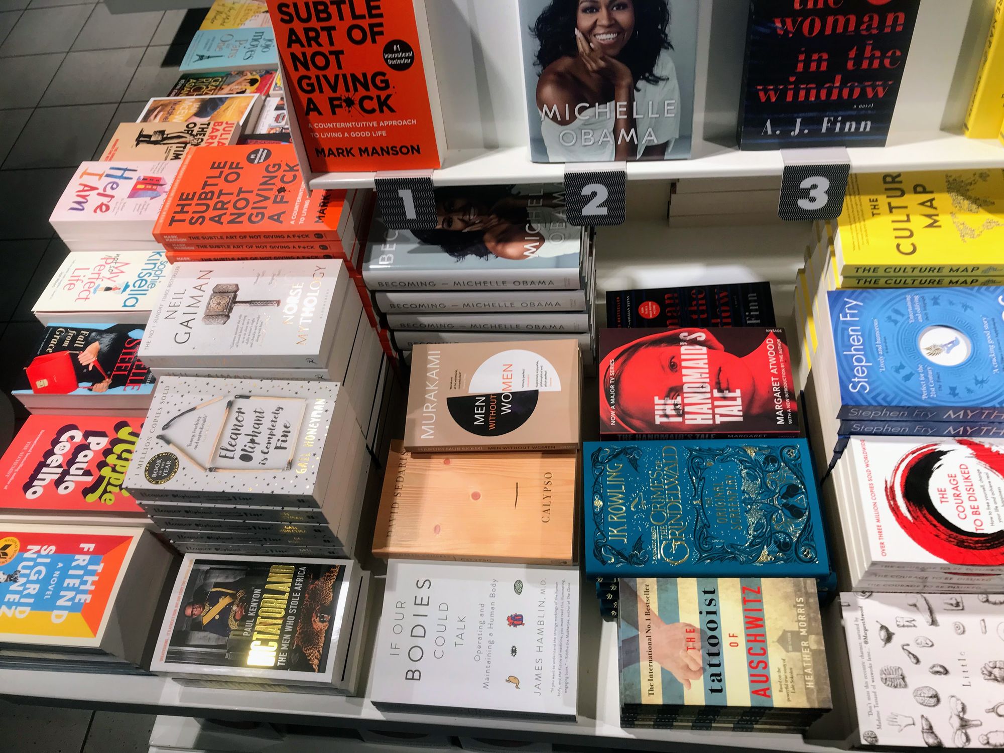 Books on display for sale on a bookstore stand